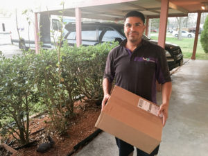 Fedex man delivering Island Batik Fabrics to the Quilt Rambler